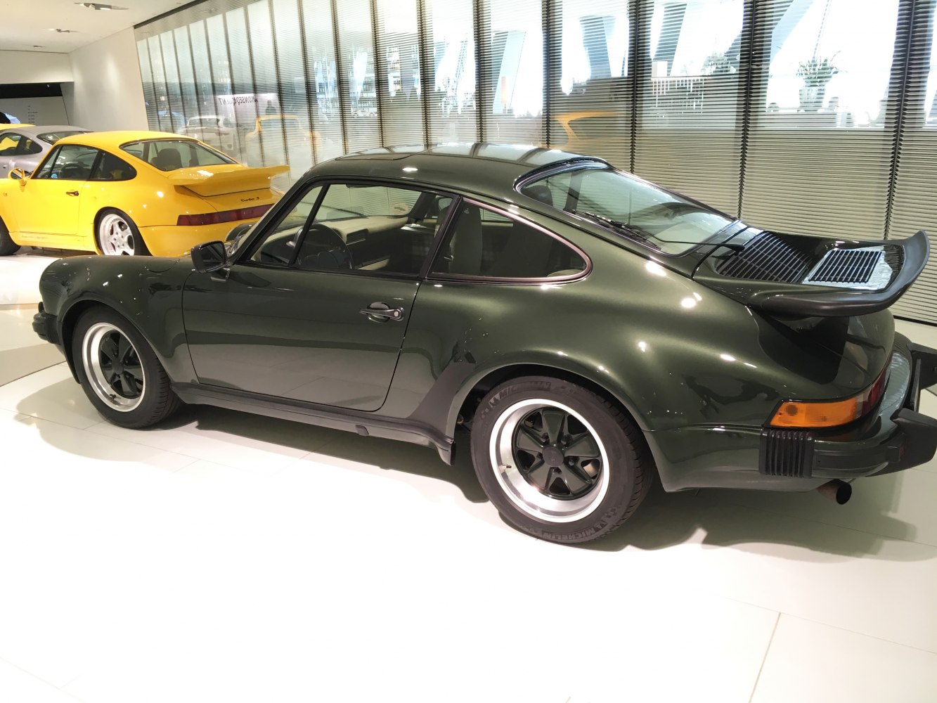 Side view of classic coupe with wide rear and distinctive spoiler