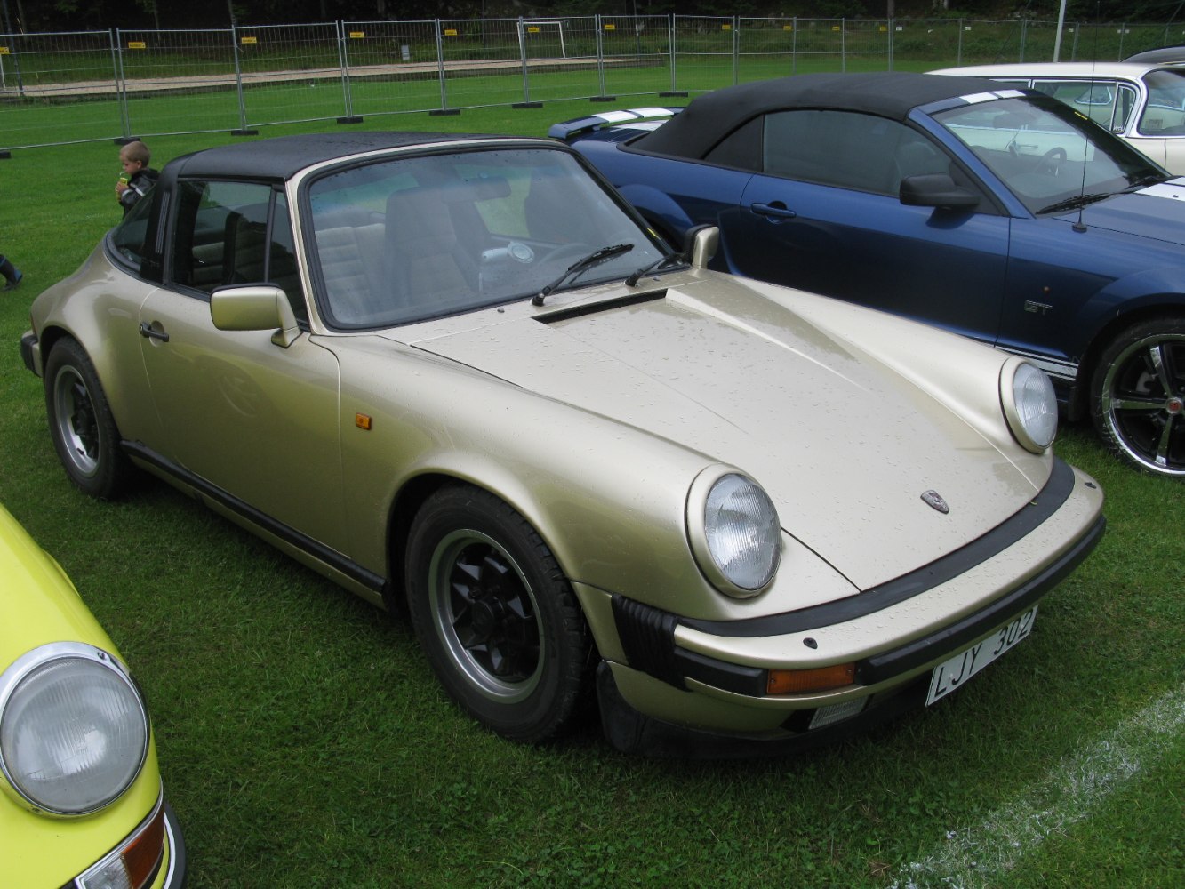 1970s sports car with Targa roof and round headlights in coupe style