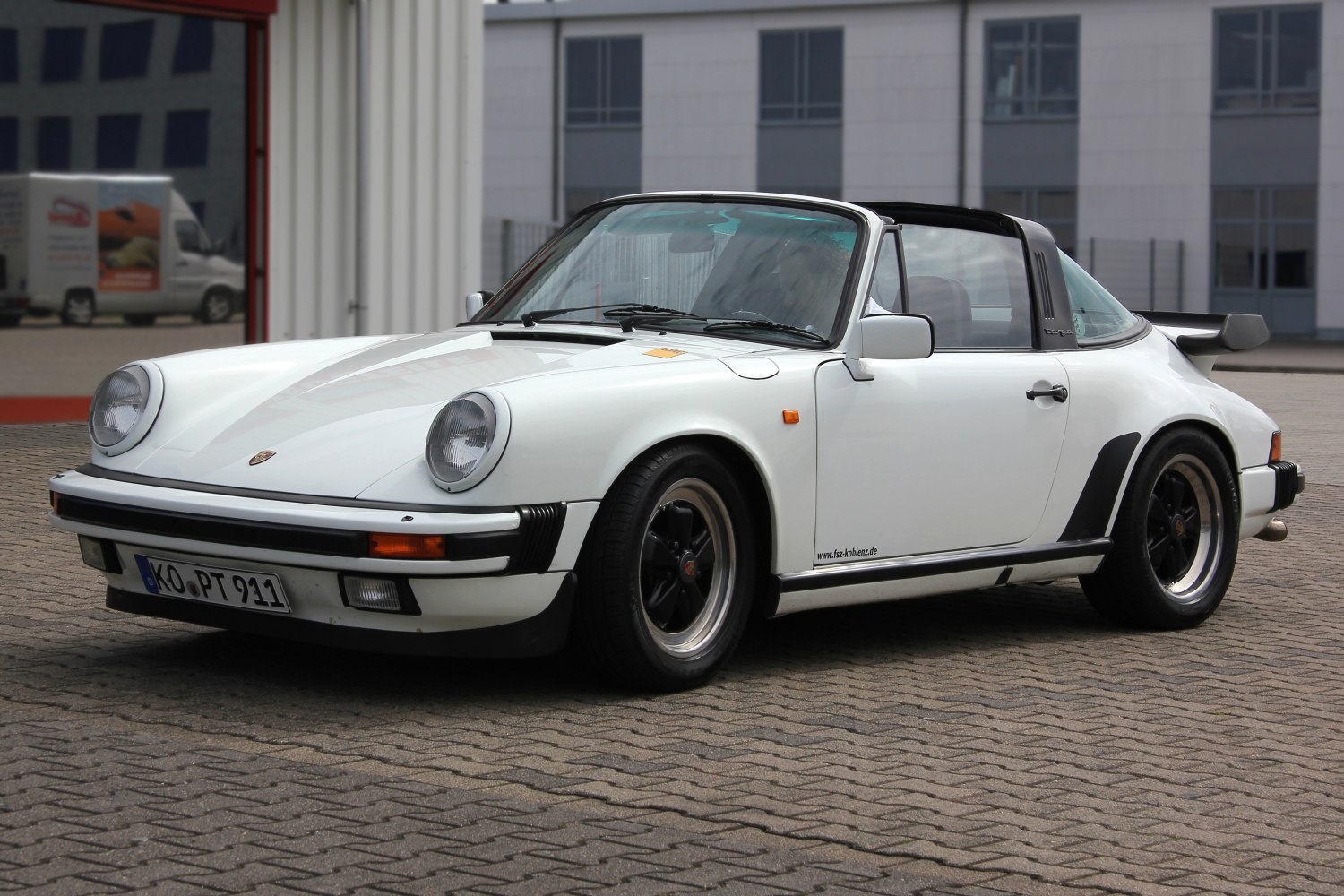 Classic sports coupe with targa roof and rear spoiler