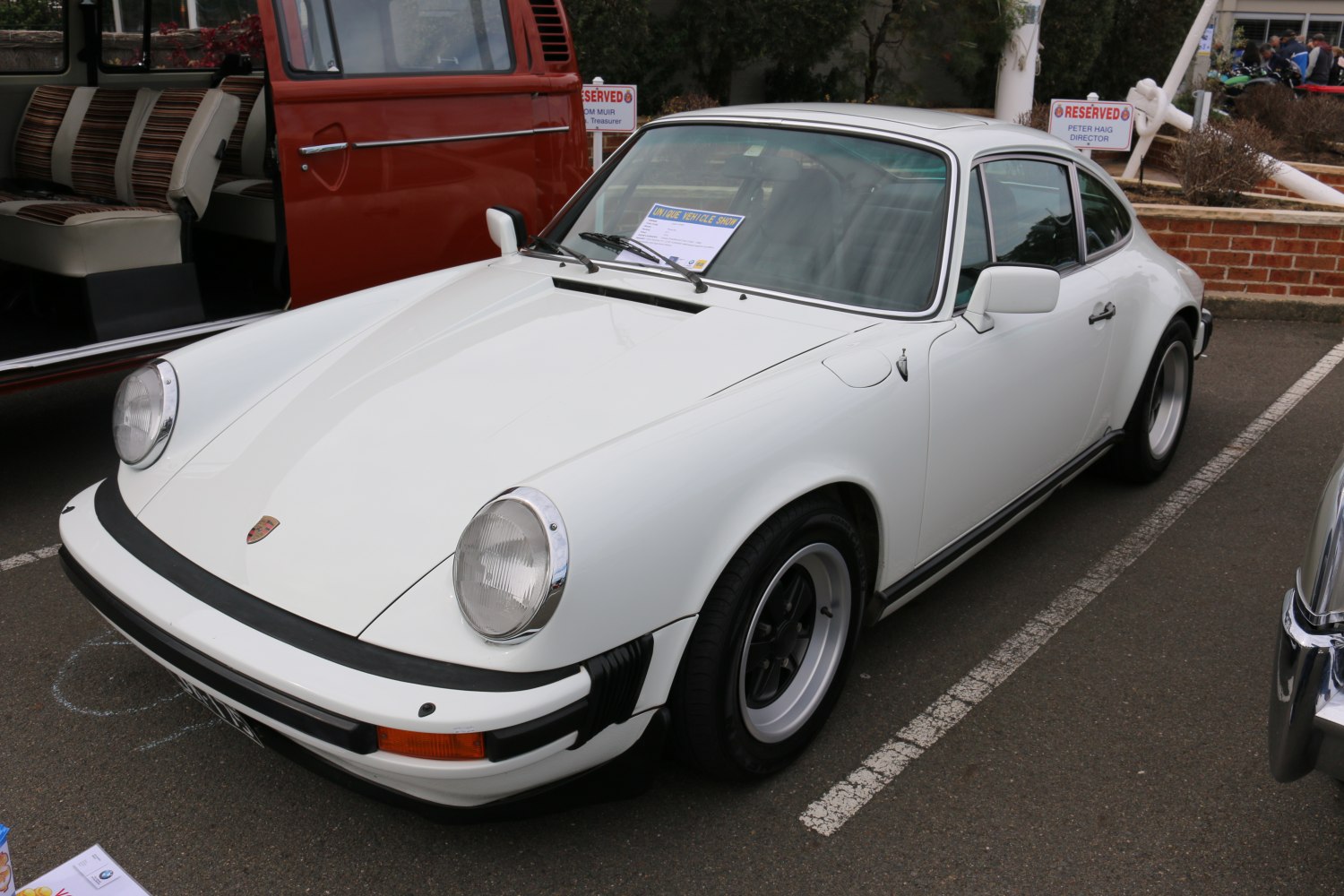 Classic coupe with round headlights and wide tires in white color