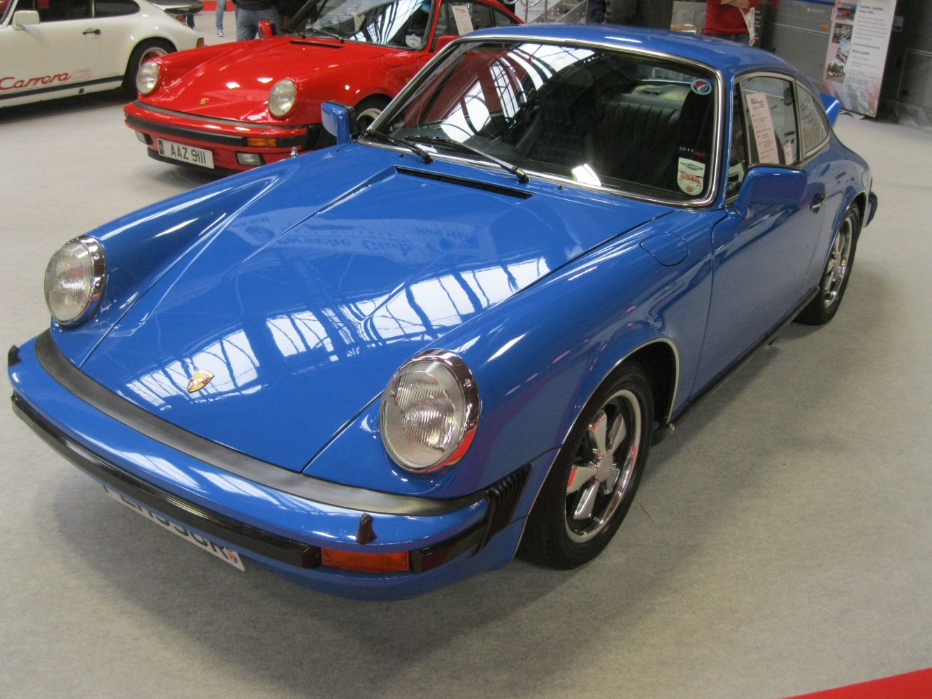 Classic sports coupe with round headlights and chrome five-spoke wheels