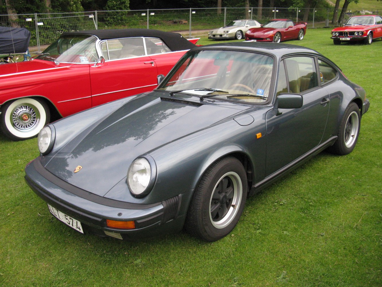 Round headlights, black wheels, vintage coupe body