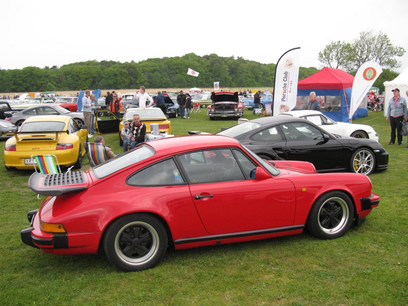 Red classic coupe with rear spoiler side profile