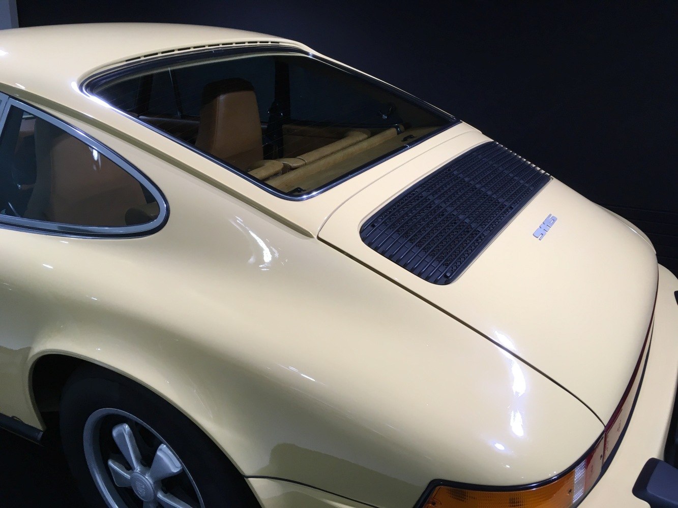 Rear quarter with sloping roofline and rear engine grille