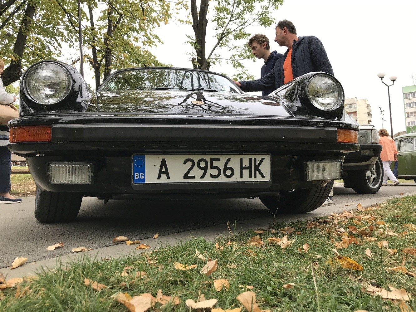 Close-up front view with round headlights and license plate.