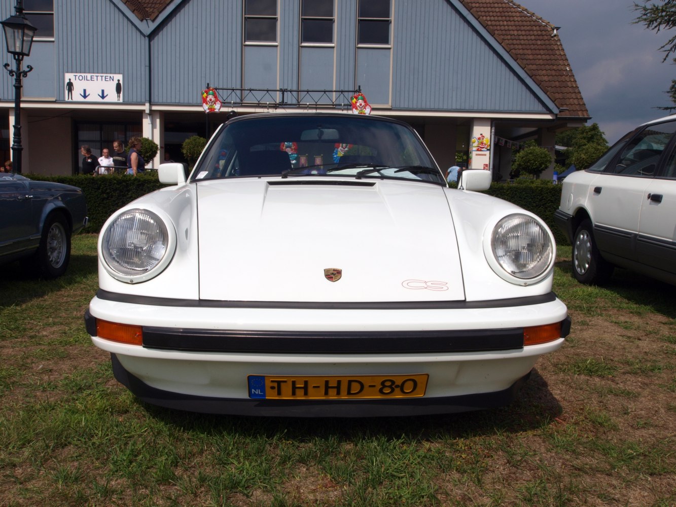 Front view of vintage sports coupe with round headlights and iconic hood design