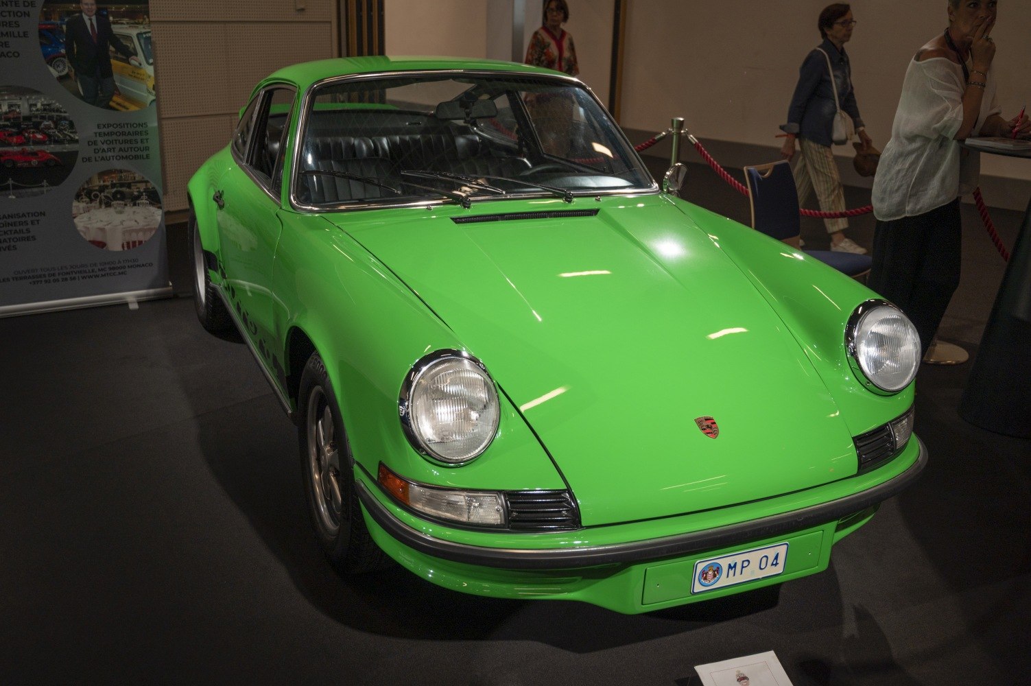 Vintage sports coupe with round headlights and sleek green body