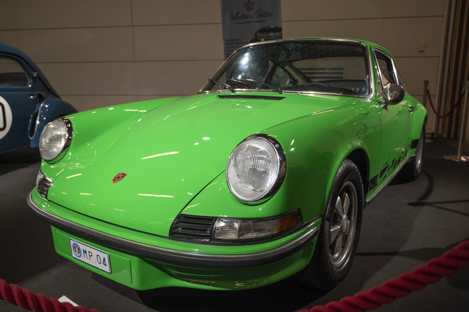 Vintage green coupe front with round headlights and sleek design