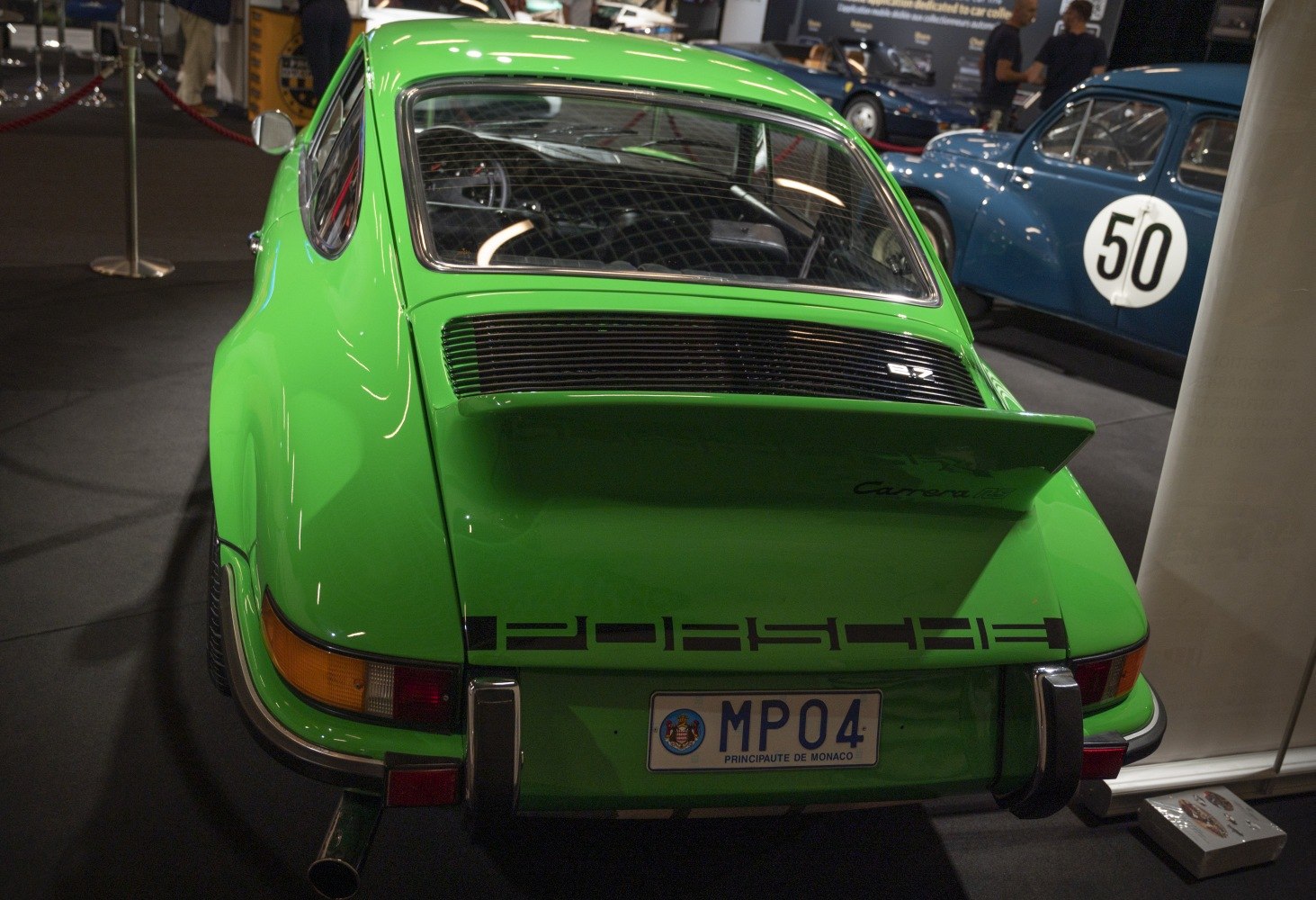 Green rear liftback with large spoiler and rear grille