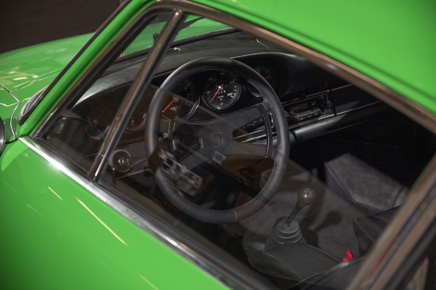 Vintage sports car steering wheel, dashboard, and manual gear shift