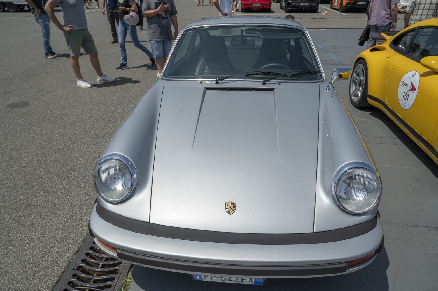 Close-up front view of classic Porsche 911 with round headlights and silver hood