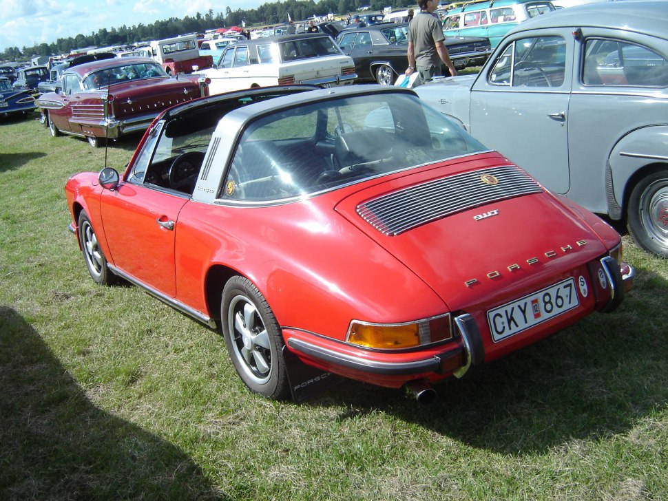 Rear view of red vintage sports car with characteristic Targa bar and chrome bumper