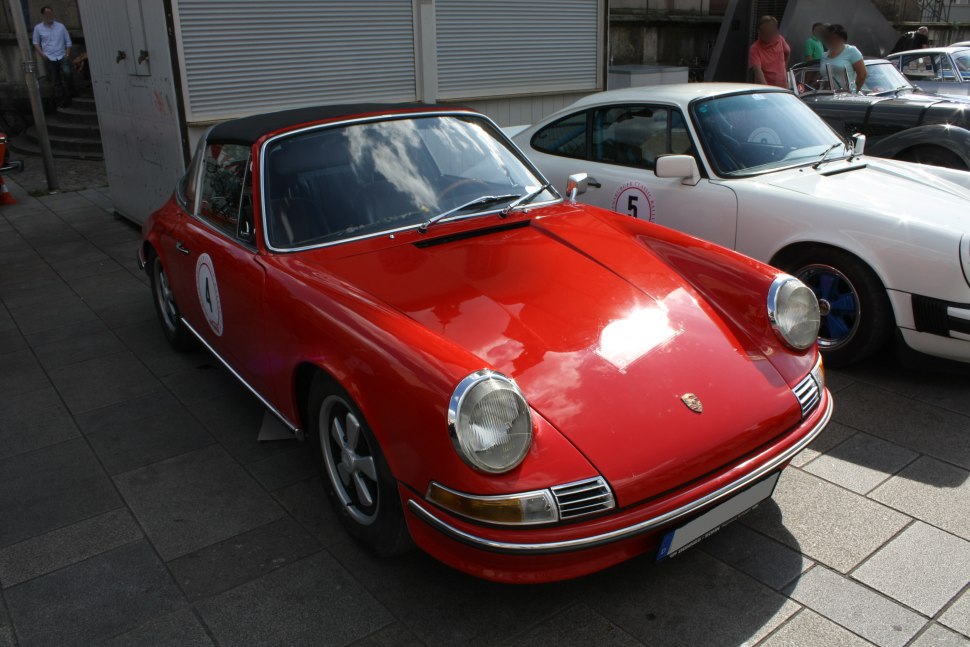 Red classic sports car with Targa roof and round headlights