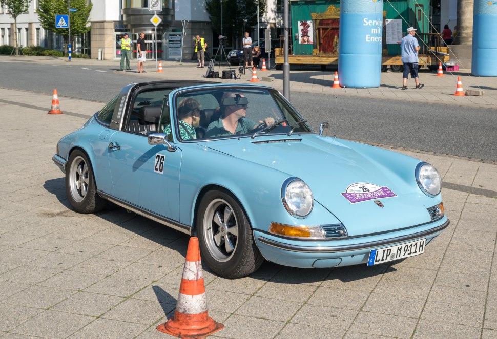 Light blue classic Porsche 911 Targa with signature Targa roof and retro styling.
