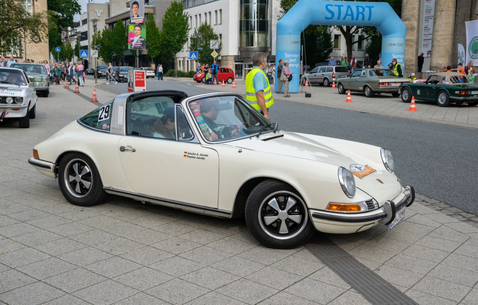 Classic Targa roof and iconic rounded headlights on a vintage sports coupe