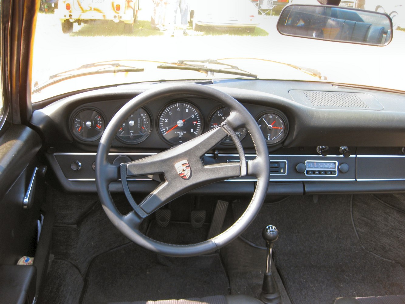 Classic vintage car interior with steering wheel and analog gauges