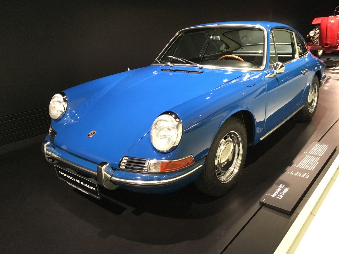 Blue coupe with round headlights and sleek classic design