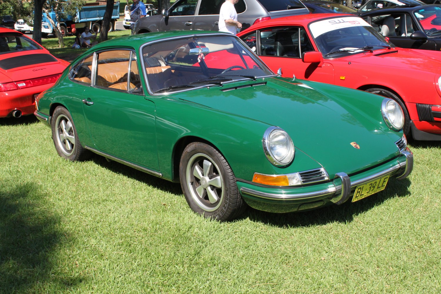 Classic green vintage coupe with round headlights and sleek silhouette.