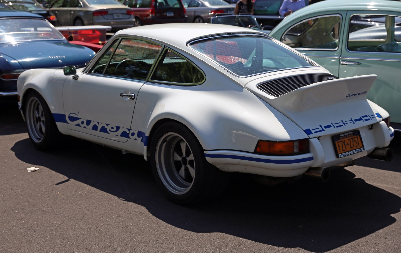 White Porsche-style coupe with distinctive rear spoiler and Carrera side decal.