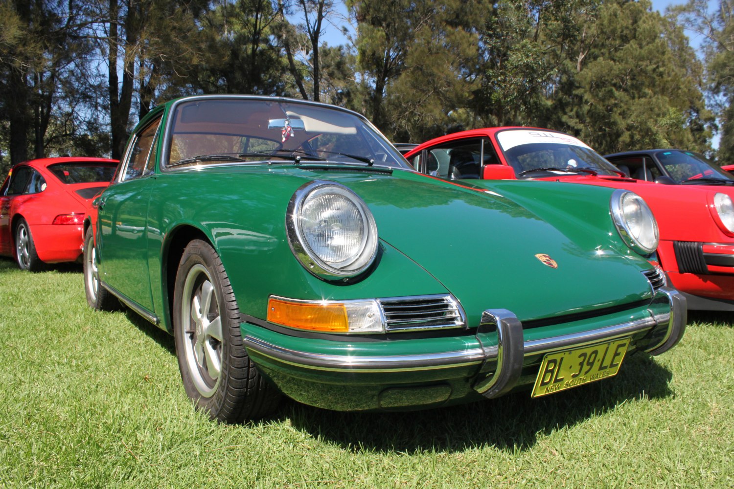 Front view of vintage car with round headlights and chrome bumper