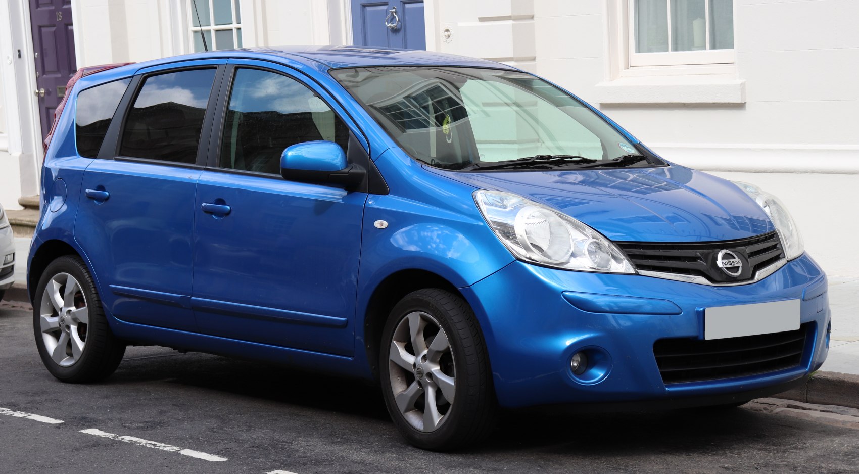 Blue 5-door compact hatchback showing side profile and front details