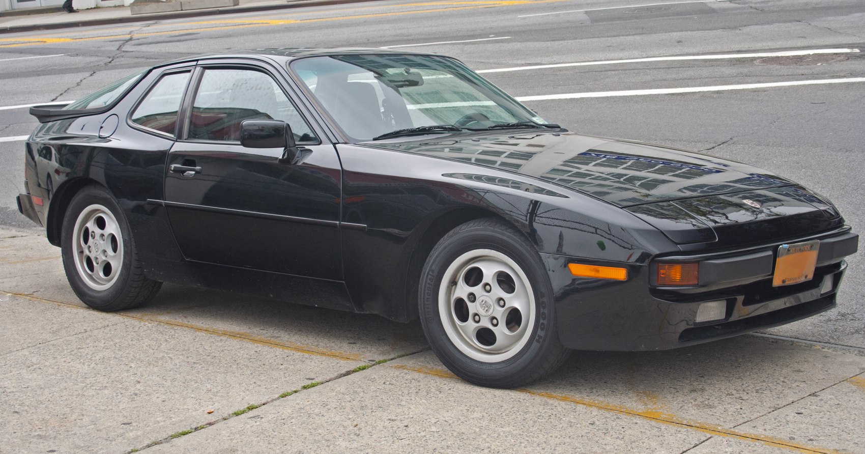 Black sports coupe with pop-up headlights and rear spoiler
