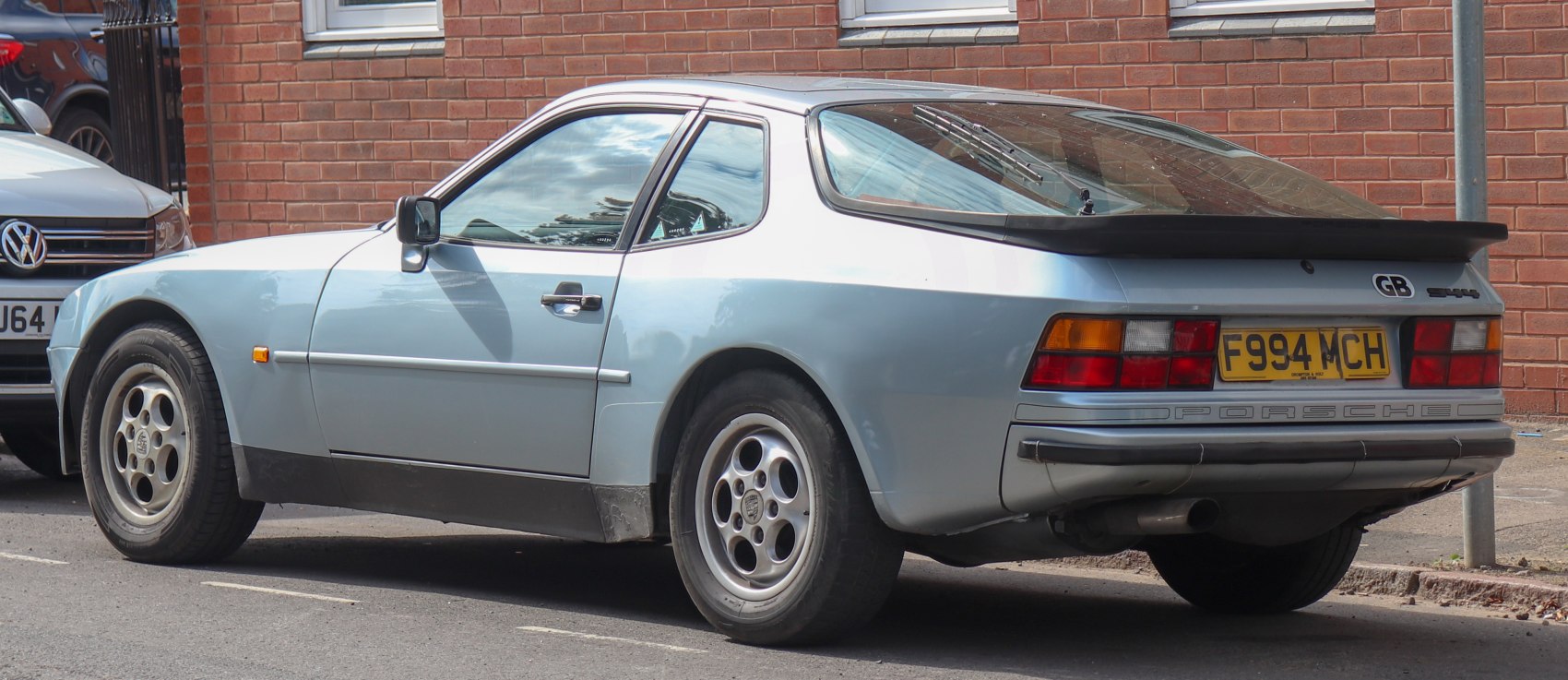 Rear side profile with distinctive spoiler and classic sporty alloy wheels