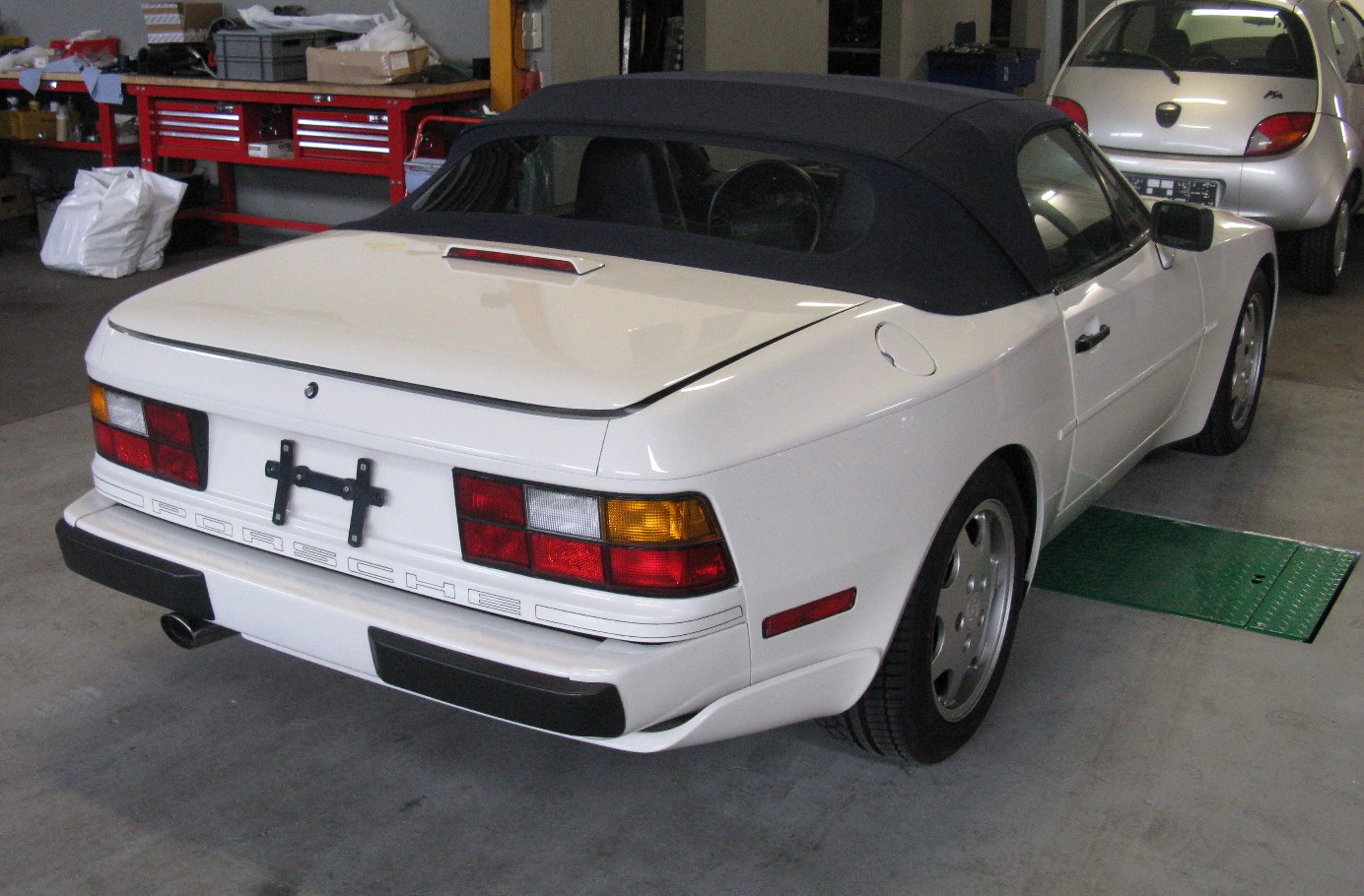Soft top convertible with distinctive rear taillights and white body