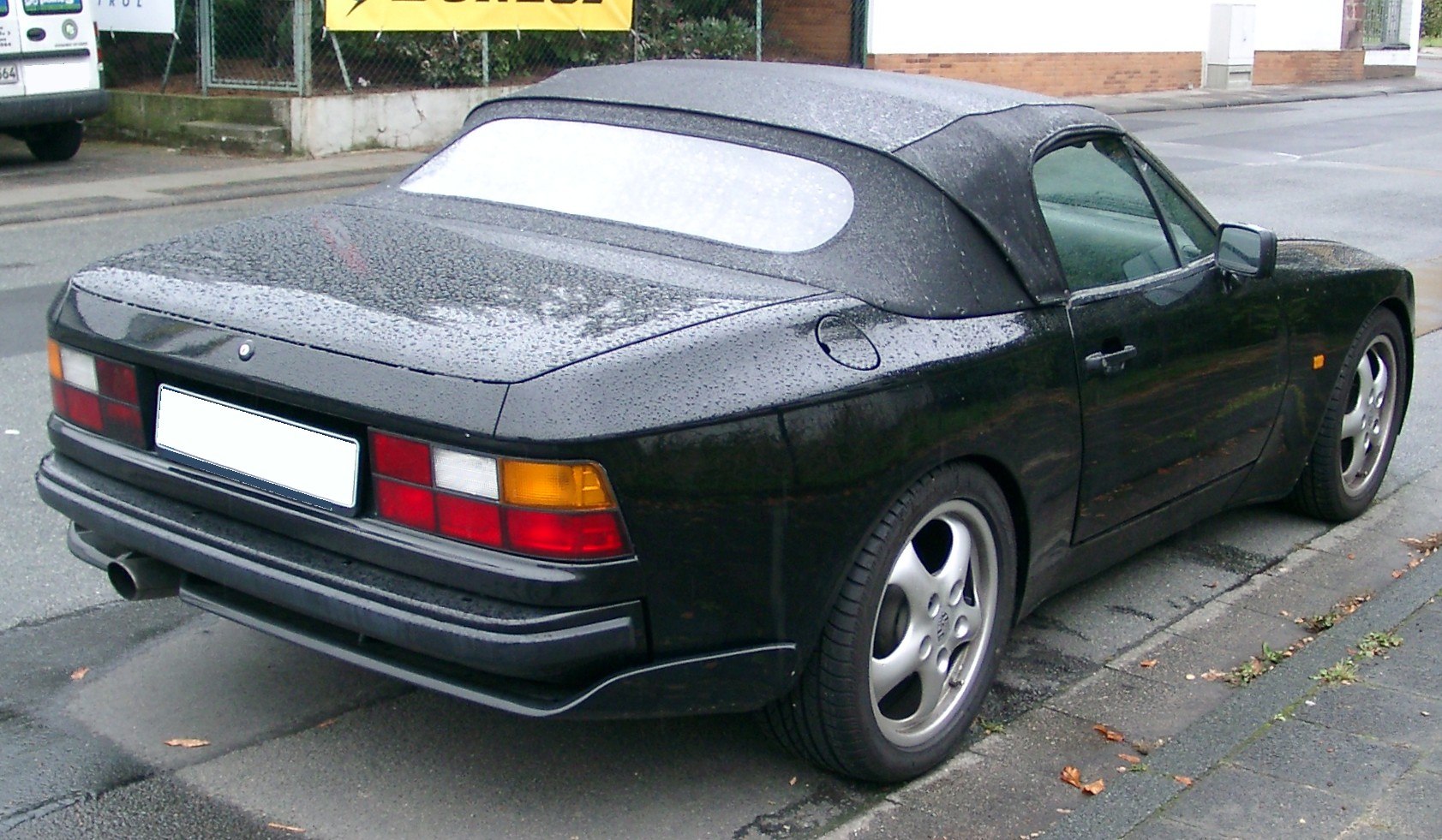 Soft-top convertible roof and rear lights with sporty alloy wheels in rainy weather