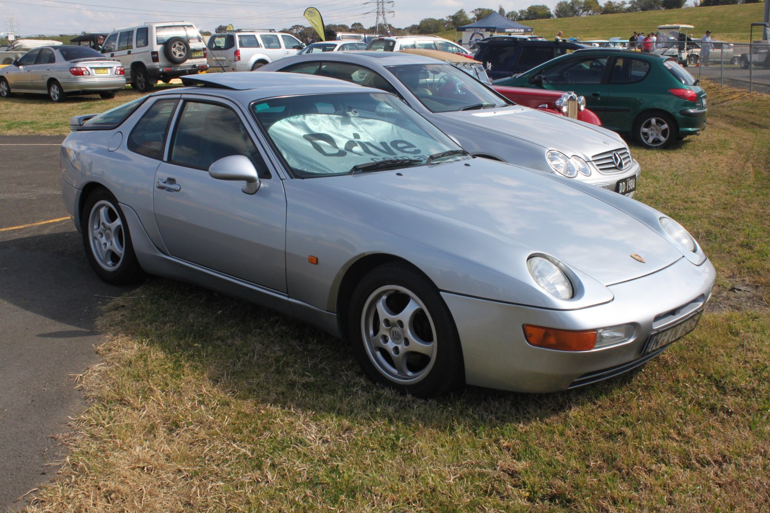 Silver classic coupe with pop-up headlights and smooth body lines