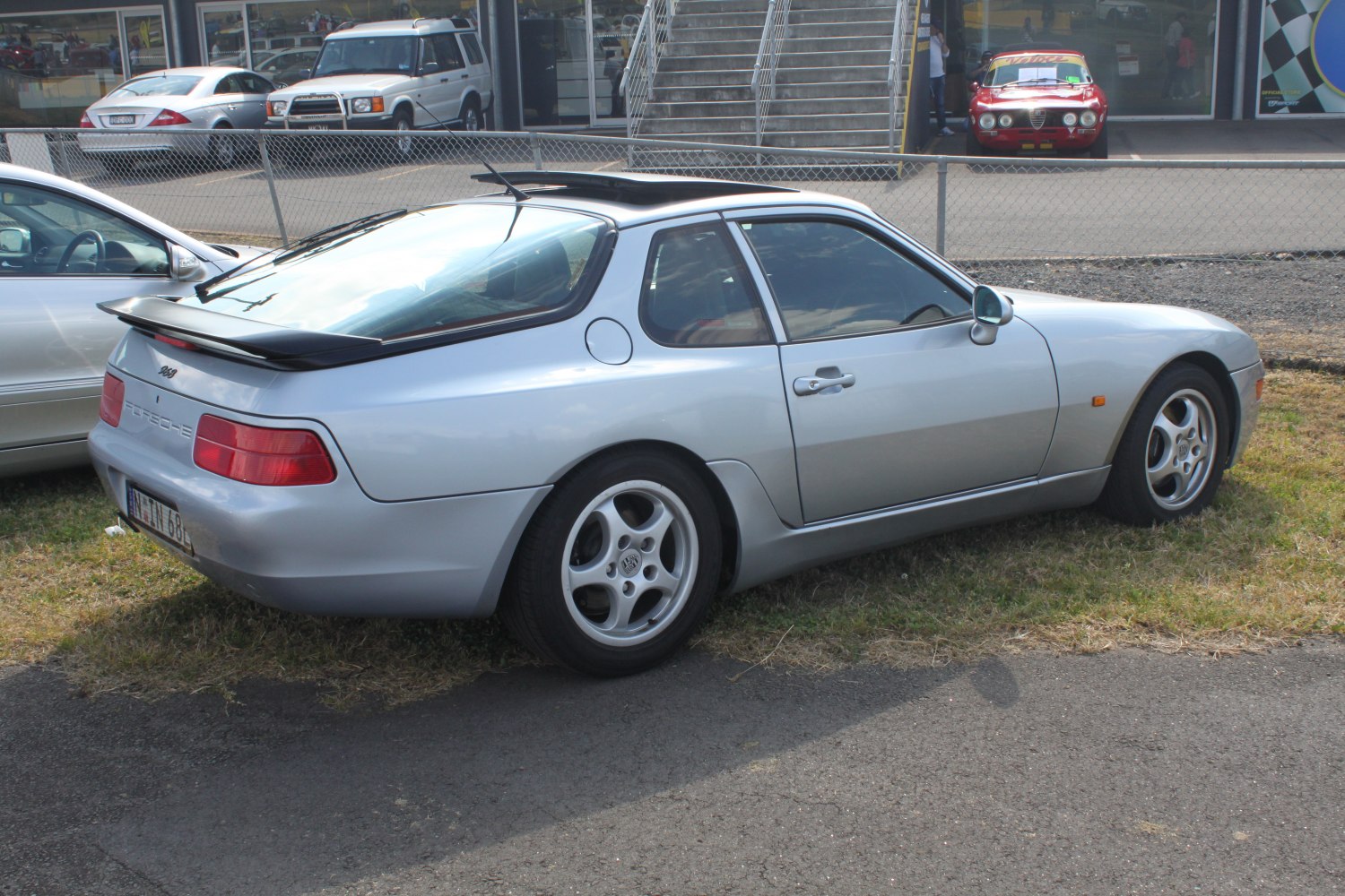 Rear side profile with pop-up sunroof and rear spoiler