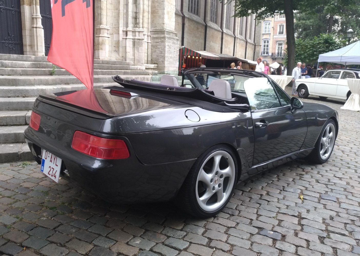 Rear and side view of a convertible with retractable soft top and alloy wheels