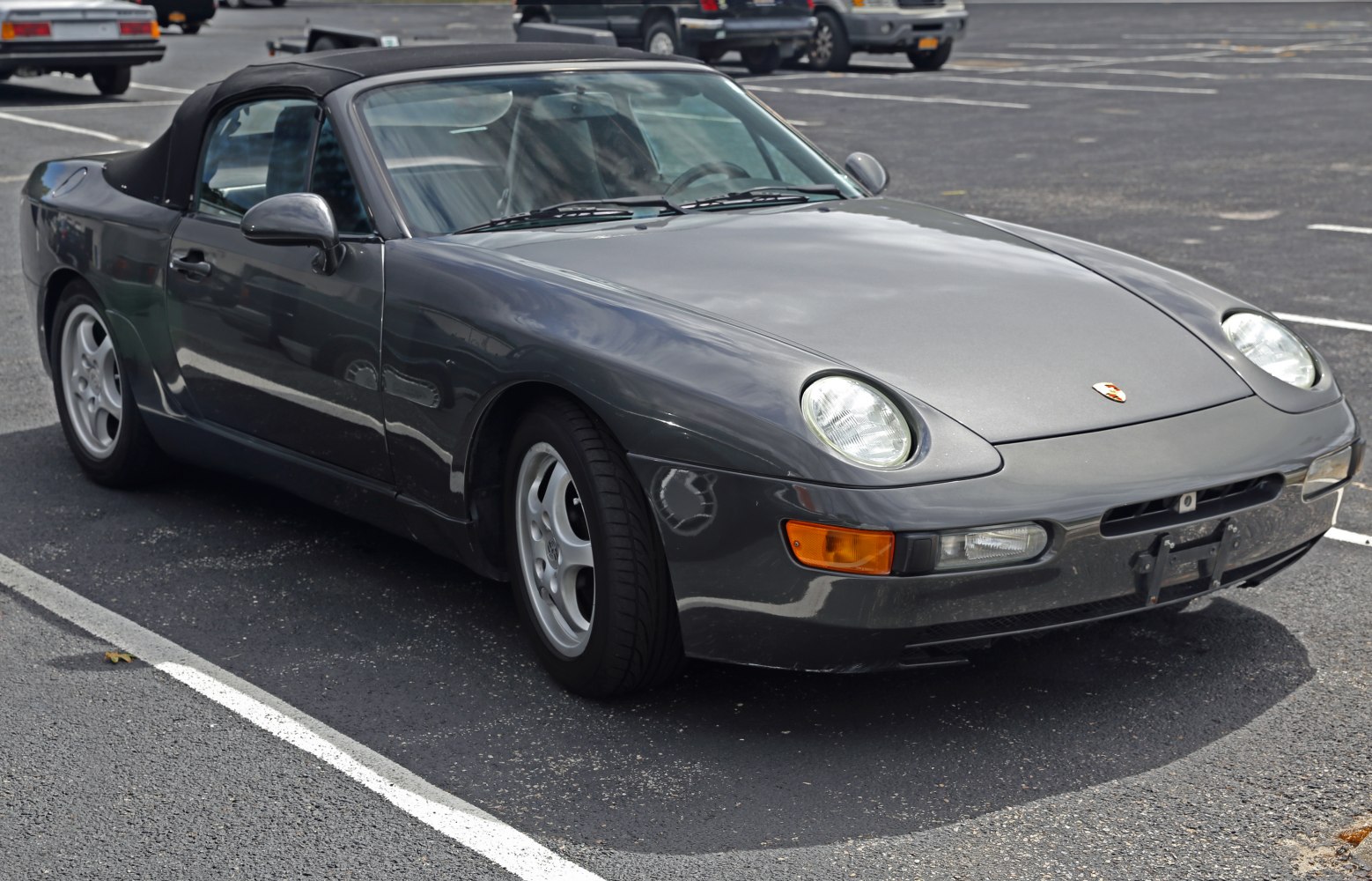 Front and side view of a convertible car with pop-up headlights