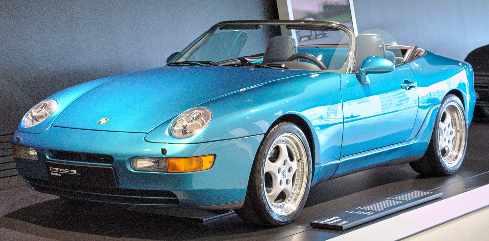 Convertible sports car with distinctive headlights and alloy wheels
