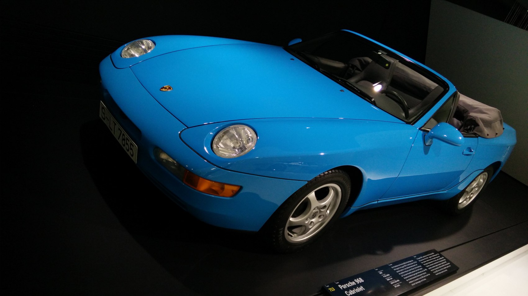 Blue convertible with round headlights and sleek front design