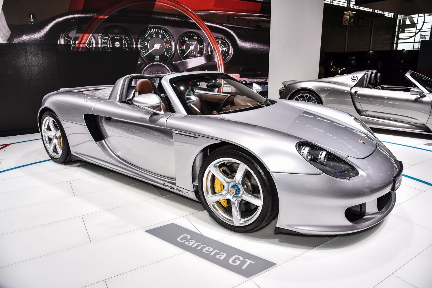 Silver convertible sports car with detailed interior and sporty wheels