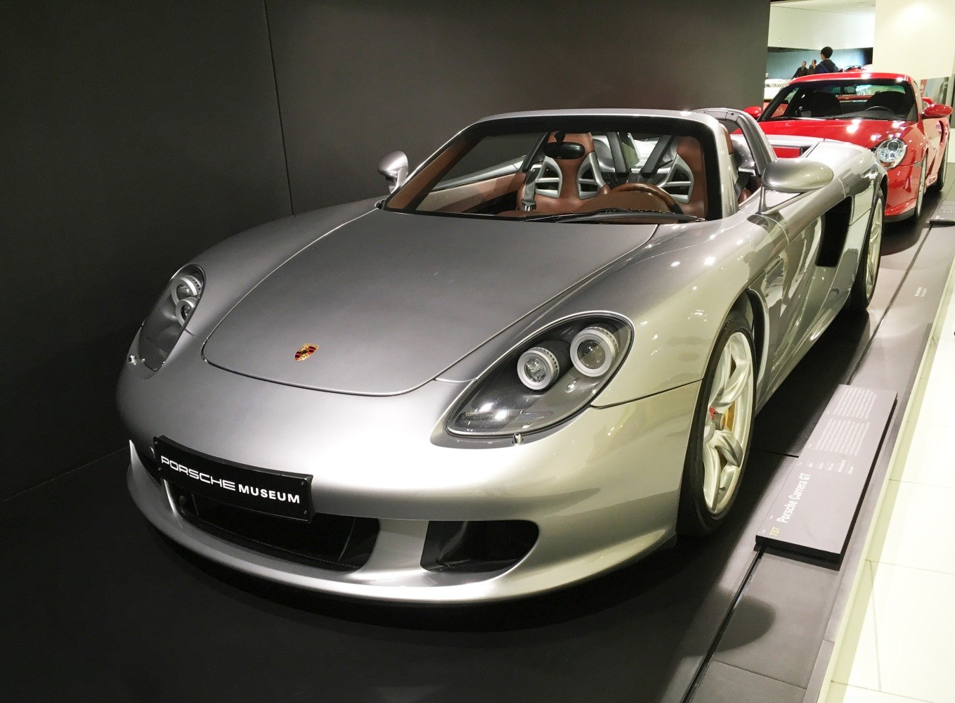 Front and side view of a sleek convertible sports car with distinctive headlights and aerodynamic styling