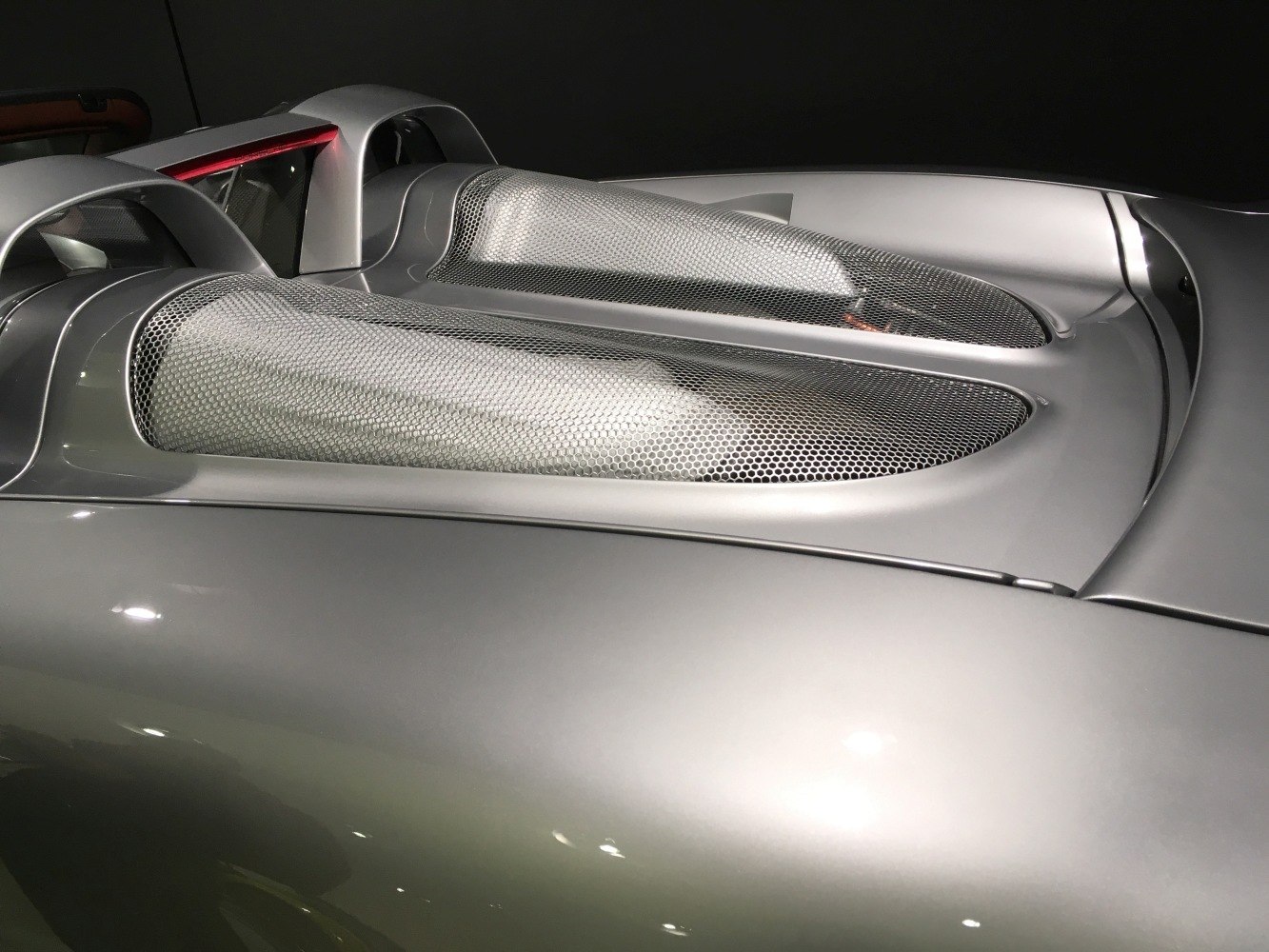 Dual mesh vents on silver aerodynamic engine cover