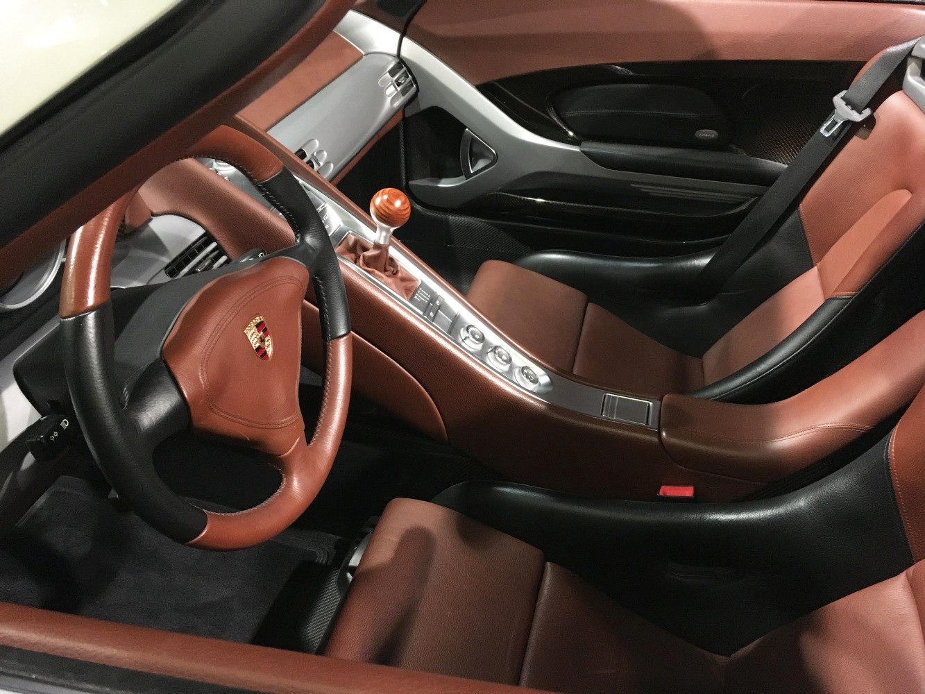 Brown and black leather interior with wood shift knob and sporty steering wheel