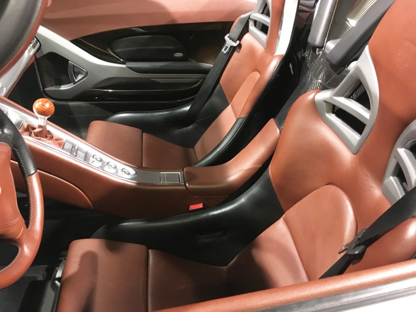 Luxury brown and black leather sport seats with gear shift and carbon fiber elements
