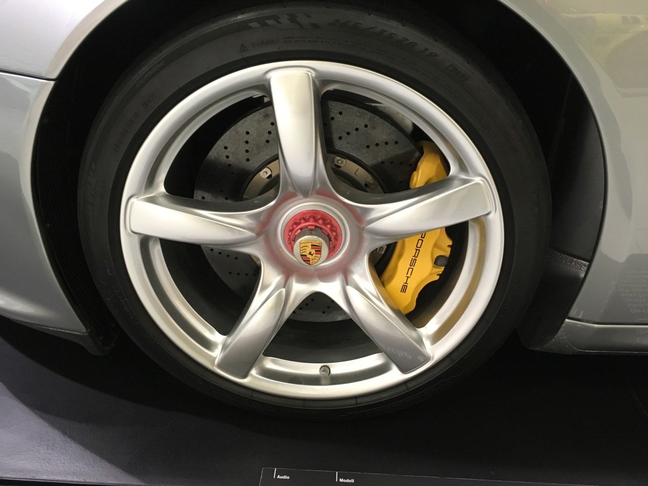 Alloy wheel and yellow brake caliper with drilled brake disc