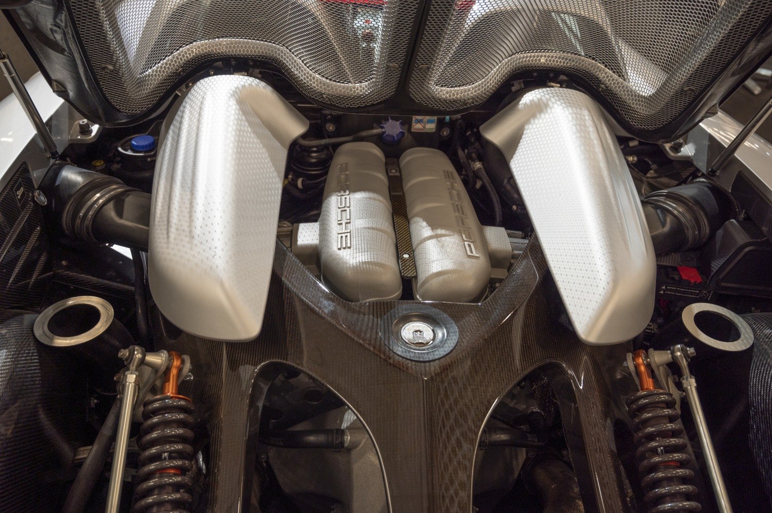 V10 engine bay with carbon fiber parts and visible suspension springs.