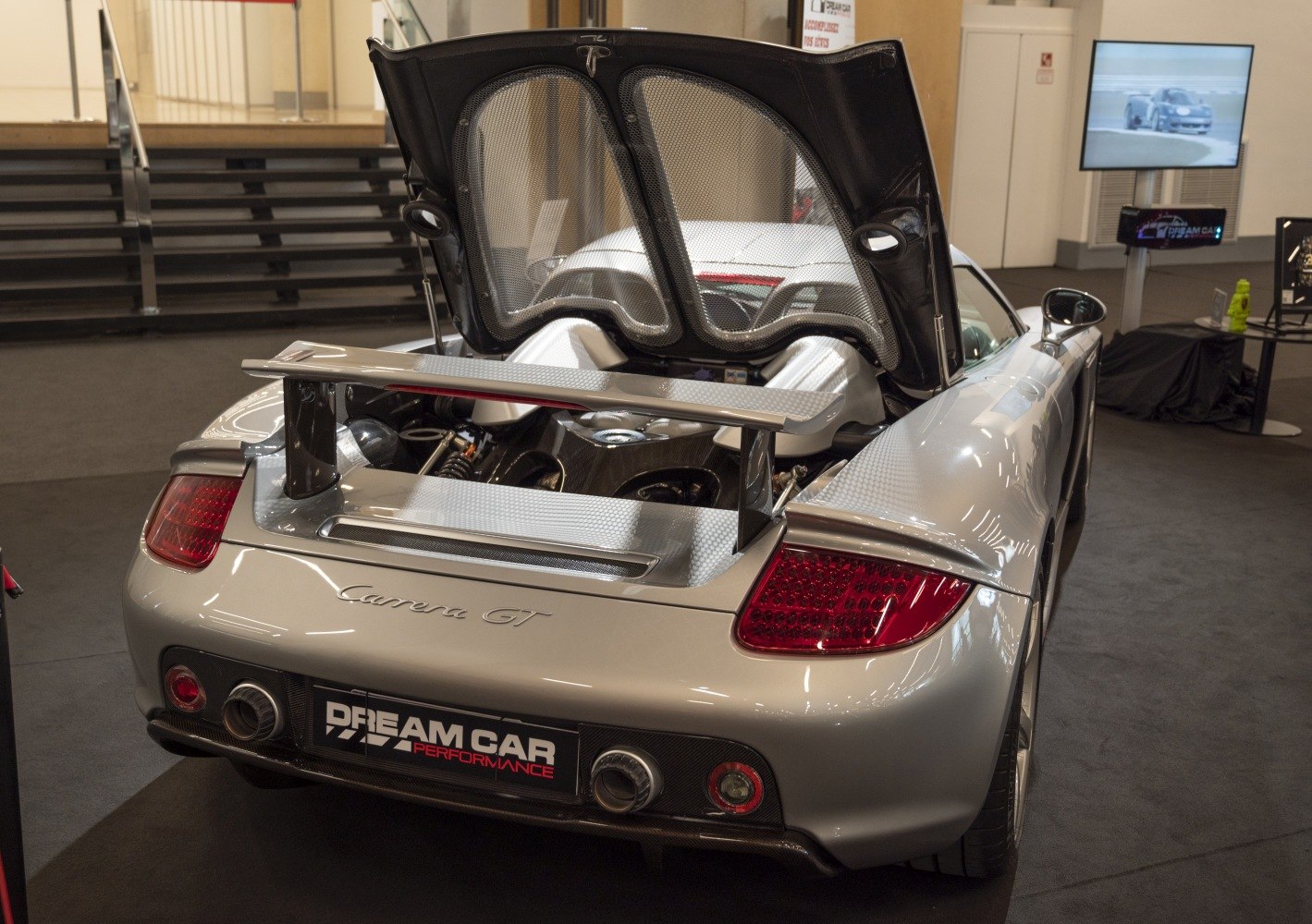 Rear view showing open engine compartment and rear spoiler