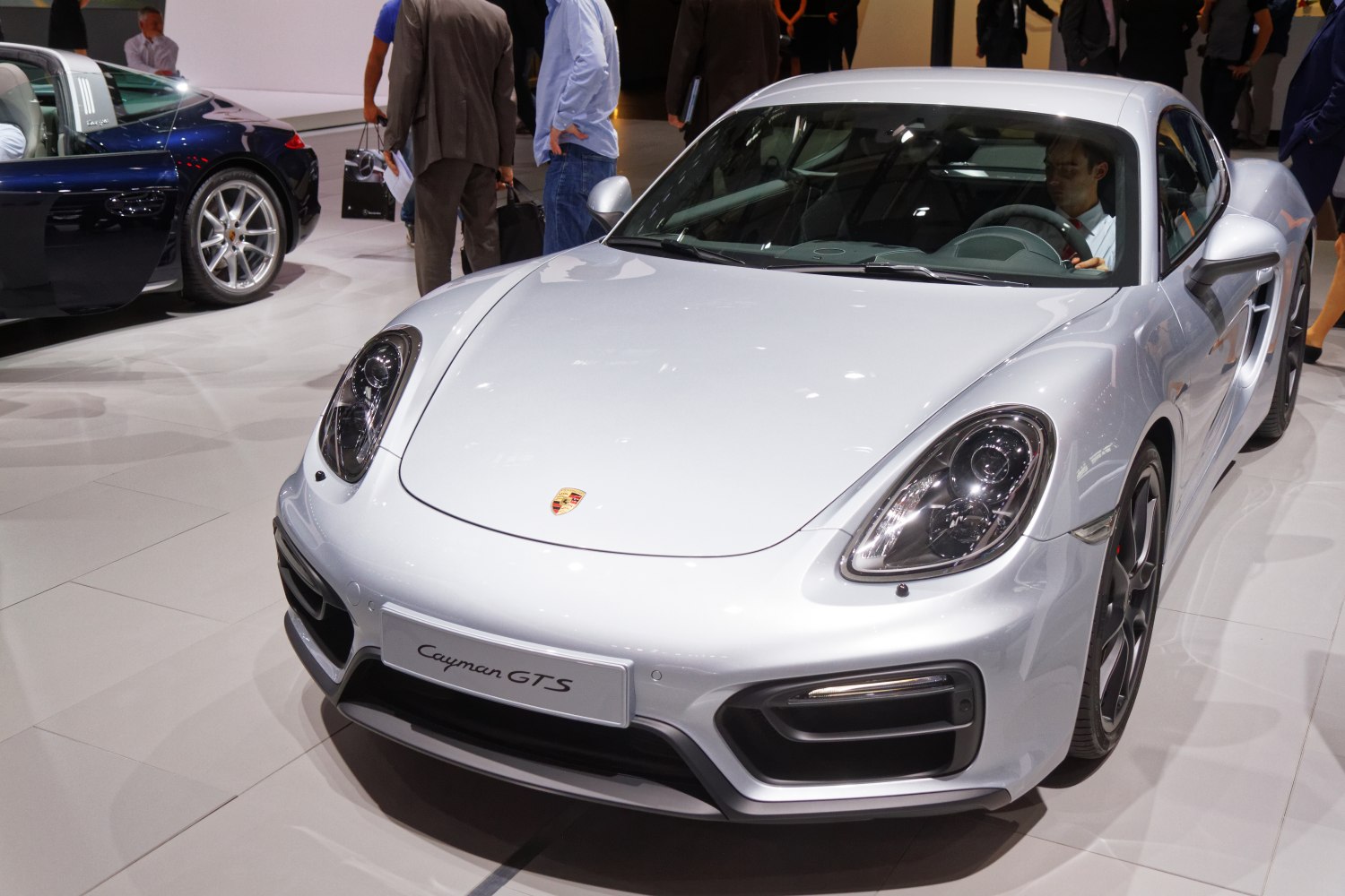Silver sports coupe front with distinctive headlights and aerodynamic bumper.