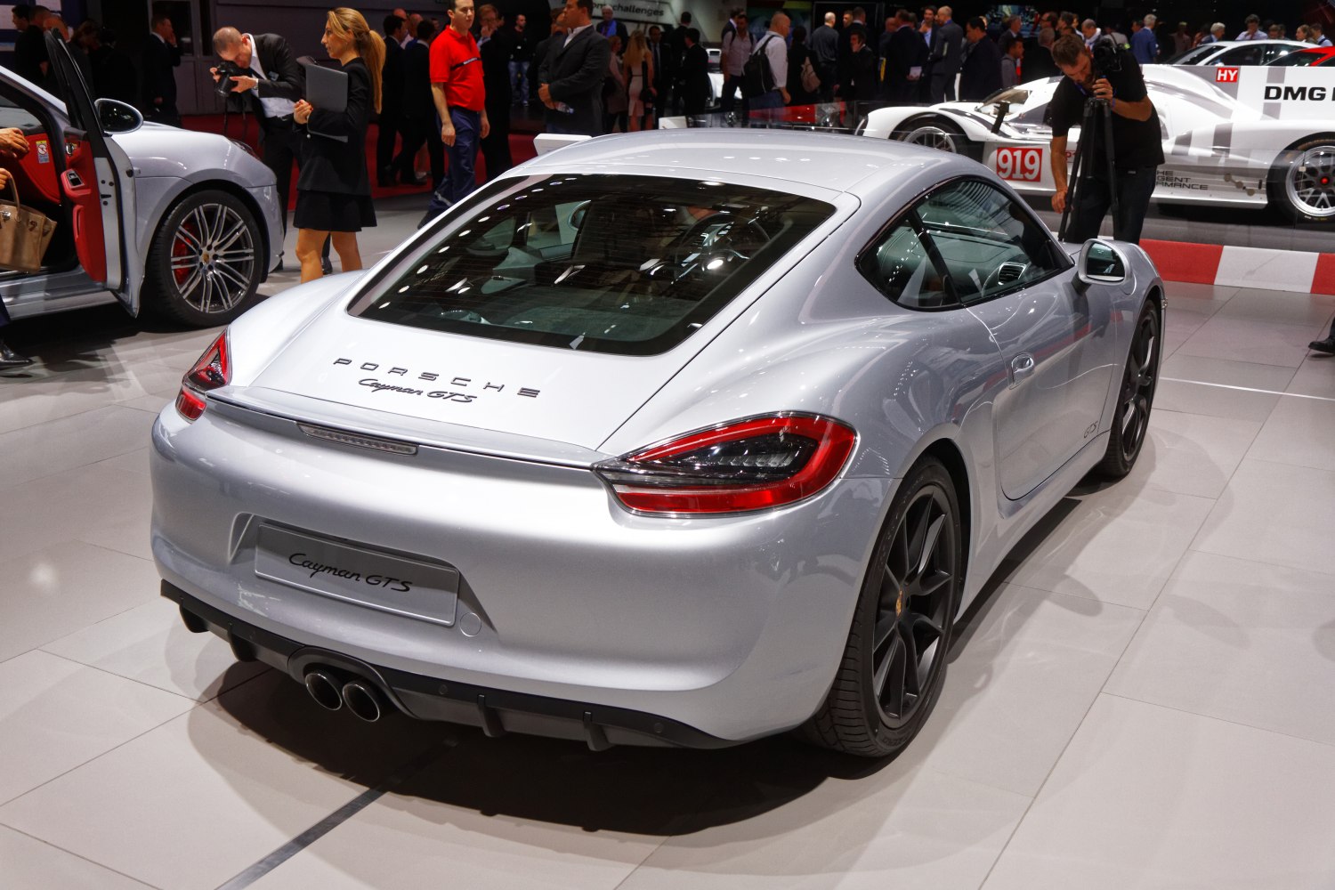Rear view of coupe with distinct taillights and dual central exhaust.