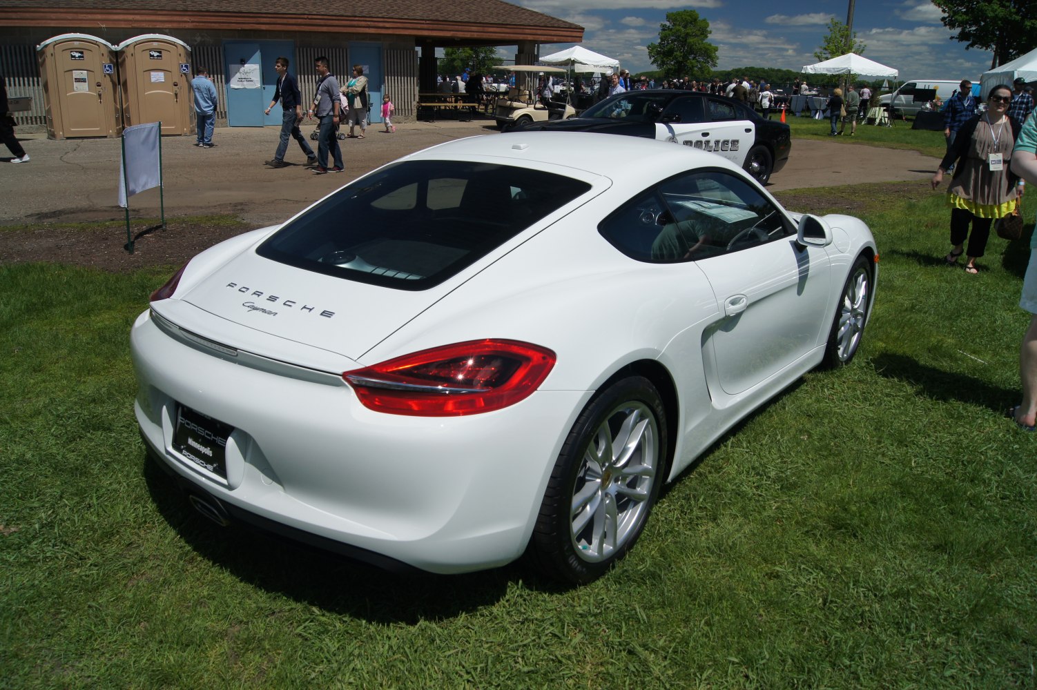 Rear and side view of a white Porsche coupe with distinctive tail lights