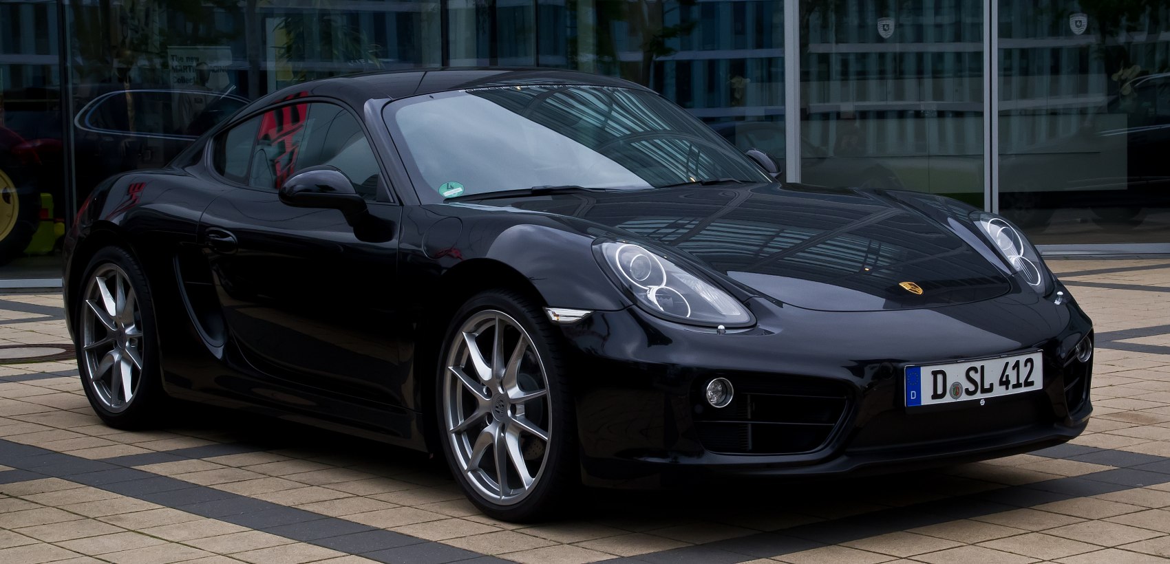 Front 3-4 view of a sports coupe with sleek headlights and alloy wheels