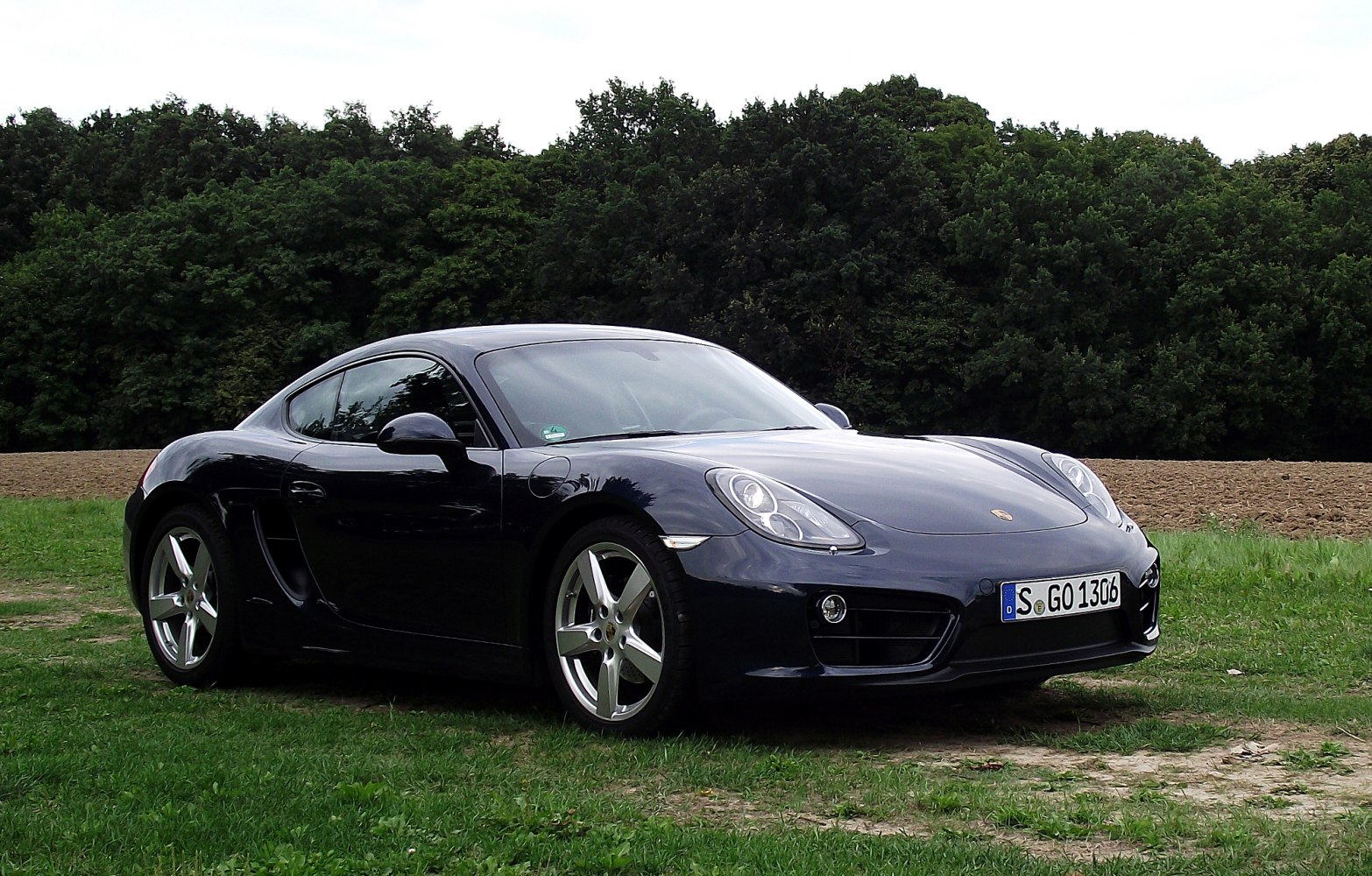 Front-side angle of a sleek coupe with distinctive headlights and side intake.