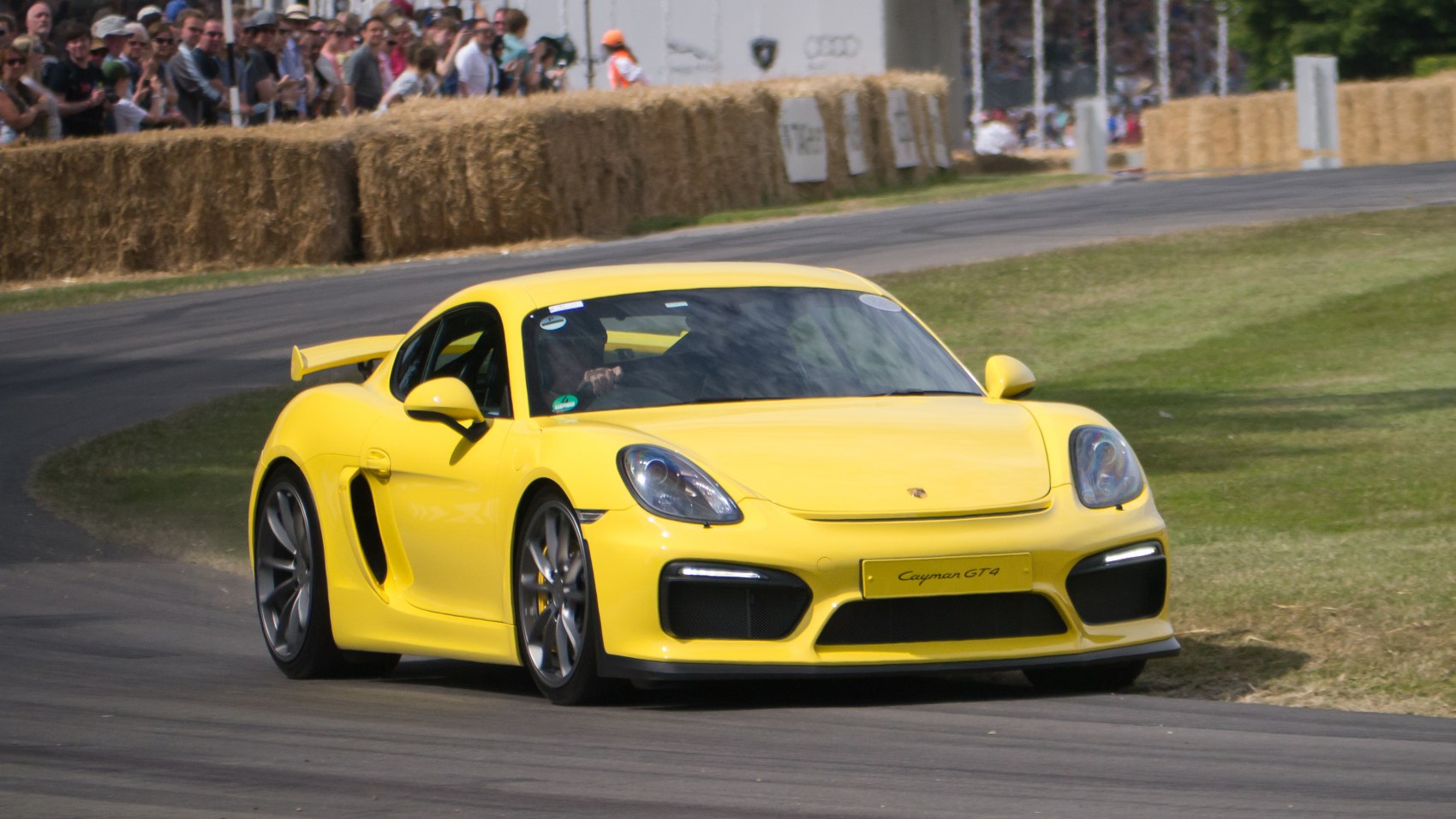 Yellow sports coupe with aggressive front bumper and rear wing spoiler