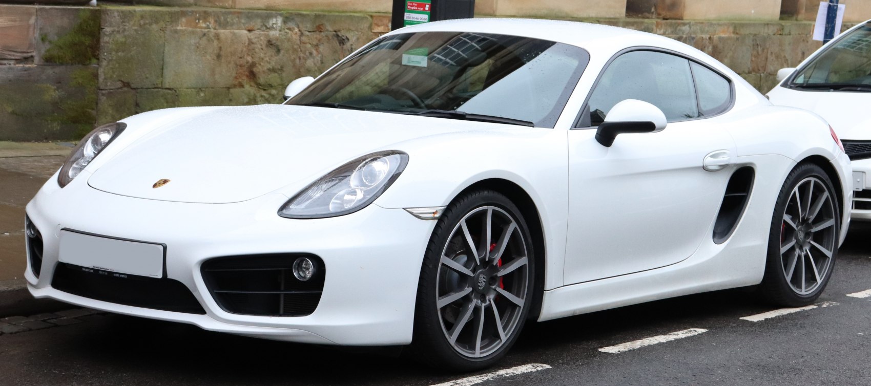 White sports coupe front side view with alloy wheels and sleek headlights